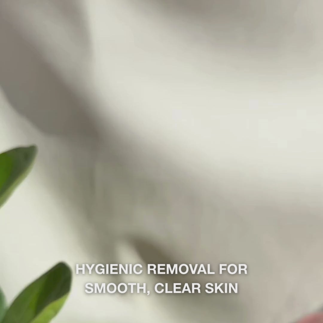A close-up video of hands using a double-ended stainless-steel blackhead remover tool on facial skin: one small metal loop gently pressed around a blackhead on the nose, followed by wiping the extracted pore debris, rinsing the tool, and then applying a soothing tonic and face cream.