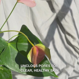 Close-up of a hand gently gliding the soft silicone-bristled Face Scrubber over damp facial skin in circular motions: the flexible brush exfoliates and cleanses deeply, lifting dirt and dead cells while revealing smooth texture, promoting a fresh, refined glow.